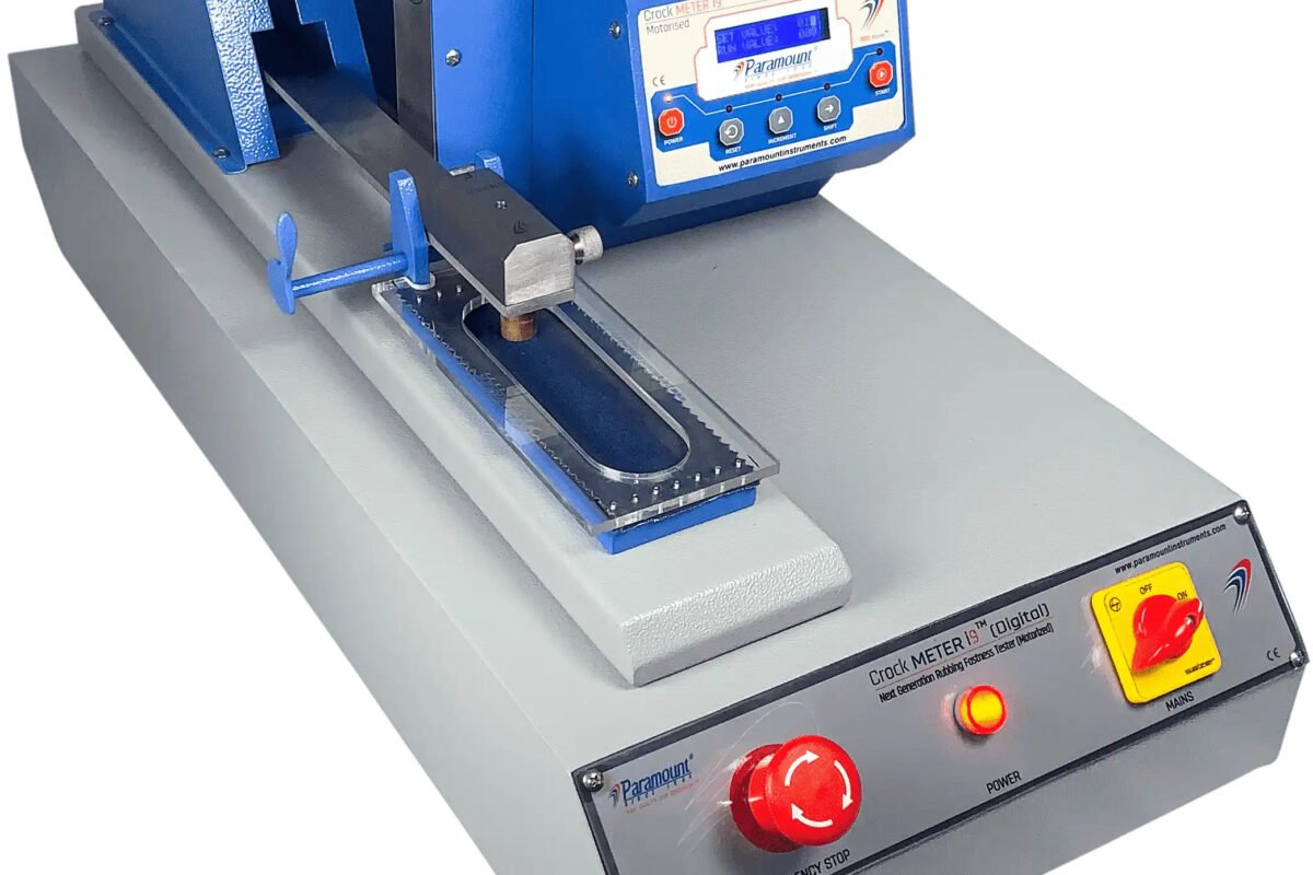 Crock meter test being performed on dyed fabric sample in a textile testing lab