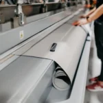 Fabric inspection machine speed being monitored during roll inspection
